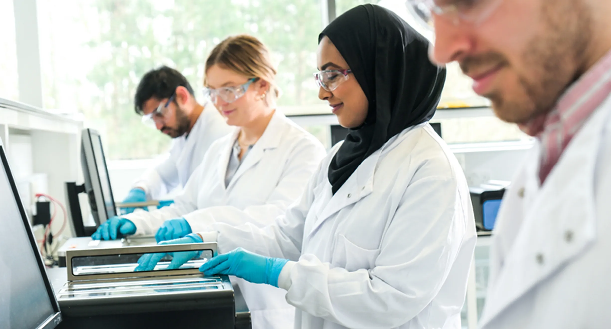Scientists at Oxford Nanopore work on a sequencing device