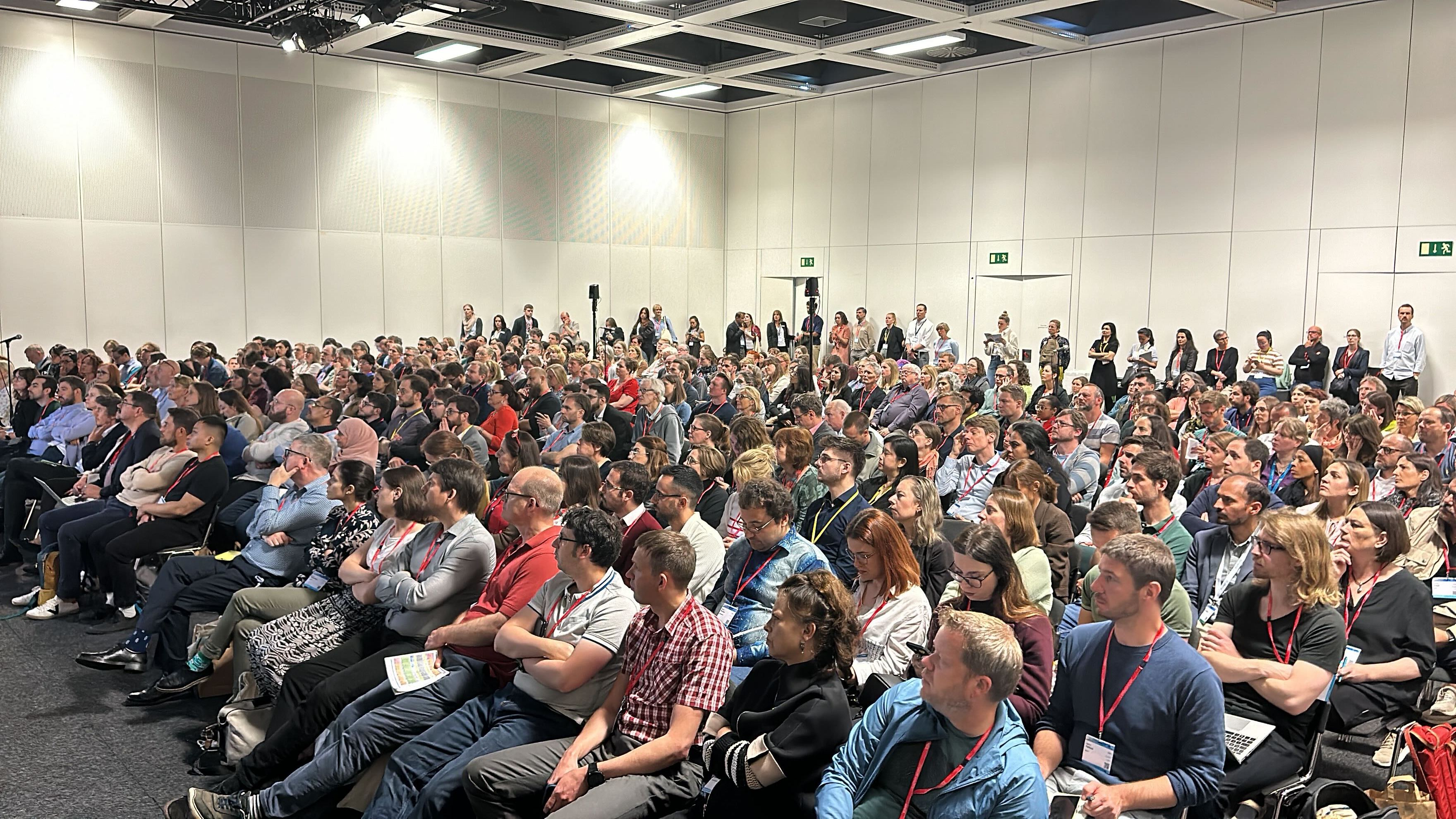 A full audience at ESHG 2024 listening intently to the speaker